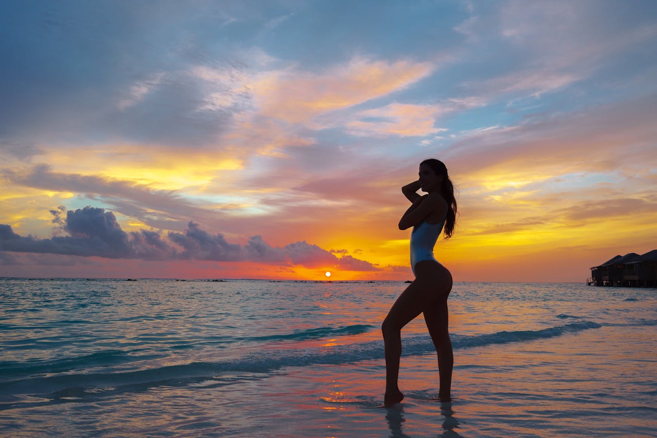 Woman on the beach at sunset